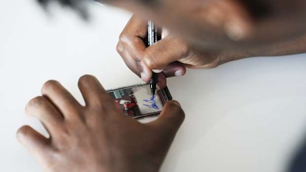 Arizona Diamondbacks prospect Gino Groover signs his baseball card.